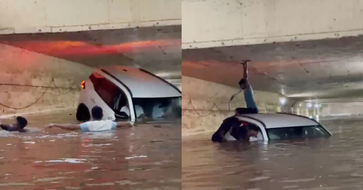 ডুবে যাওয়া গাড়িতে আটকে পড়া মানুষের বাঁচার চেষ্টা (ভিডিও)